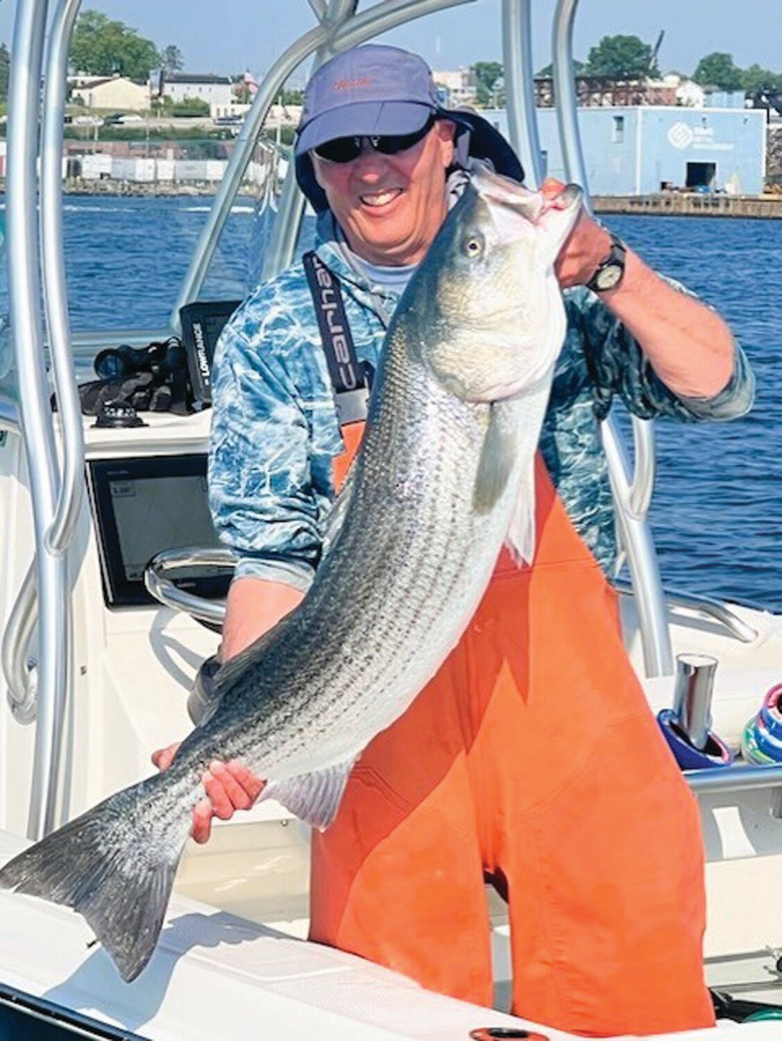 BIG BASS: Mike Swain of Coventry, an expert large striped bass angler, caught and released this 30-pound striper last weekend in the upper Providence River, using a live Atlantic menhaden (pogie) as bait. (Submitted photos)